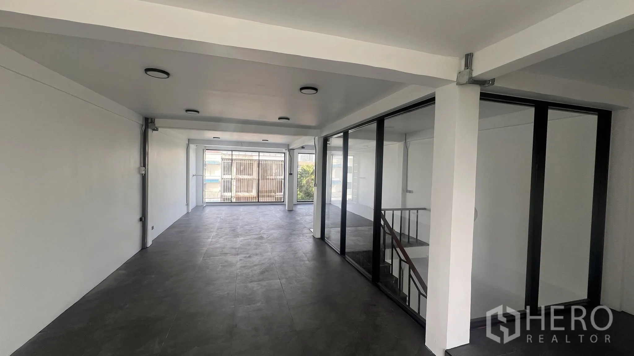 โฮมออฟฟิศ for rent or sale in Phra Khanong, Bangkok - ชั้นสำนักงานโล่งพร้อมผนังกระจกและทางขึ้นบันได.