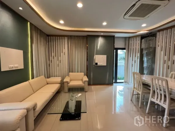 บ้าน ให้เช่าในSaphan Sung, Bangkok - โถงรับแขกและทานอาหารแบบเปิดโล่ง ไฟดาวน์ไลท์ โซฟาสีครีม และโต๊ะกระจก