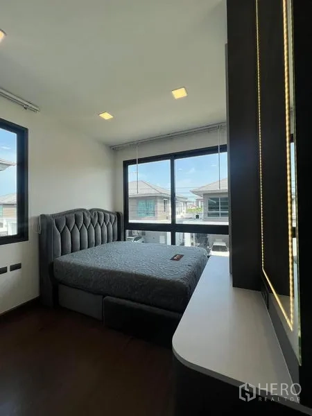 Detached House for rent or sale - Bedroom with floor-to-ceiling corner windows and vanity.