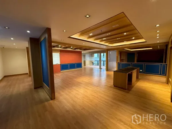 Office Space for rent in Khlong Toei, Bangkok - Spacious open-plan office with wood floors, coffered ceiling lights, and a reception island.