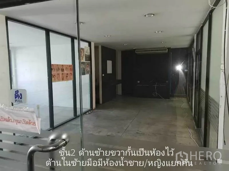 Home Office for rent in Khlong Toei, Bangkok - Interior corridor with glass partitions, ceiling lights, and air-conditioning.