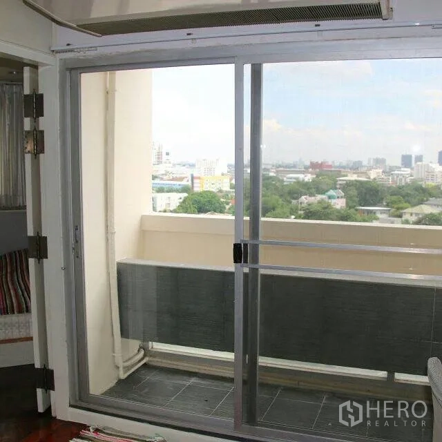 Condominium for rent in Watthana, Bangkok - Sliding glass door opening to a balcony with wide Bangkok skyline and green views.