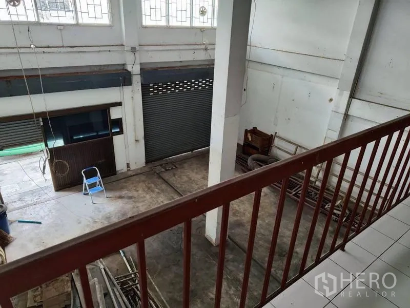 Shophouse for sale in Pathum Thani - View from mezzanine toward roller shutters and front loading area.