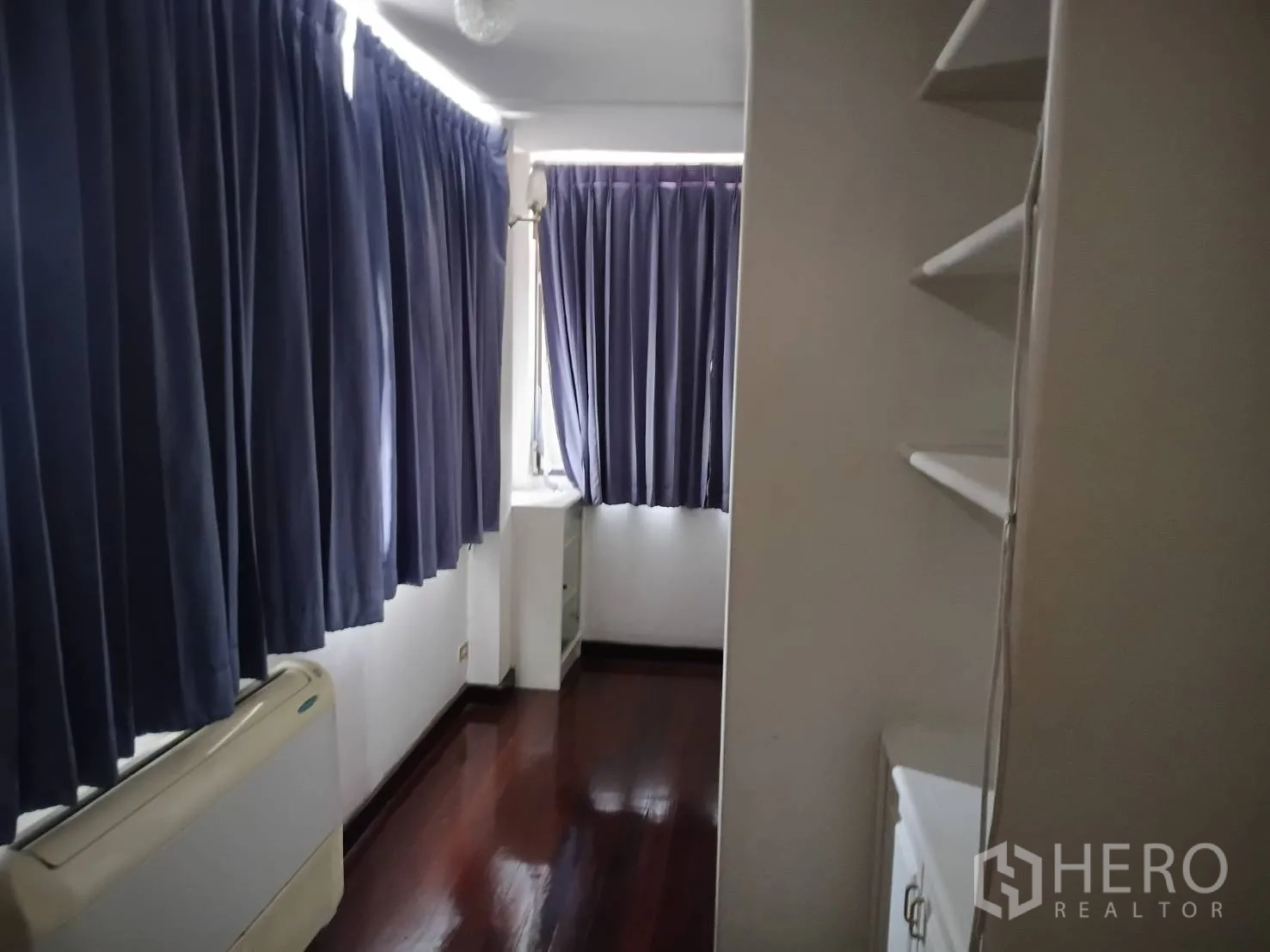 Detached House for sale in Watthana, Bangkok - Narrow room with blue curtains, shelving, and an air unit.