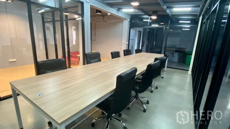 办公空间 出租在Sathon, Bangkok - 开放式会议区设长工作台与金属框玻璃墙，引入充足自然光。