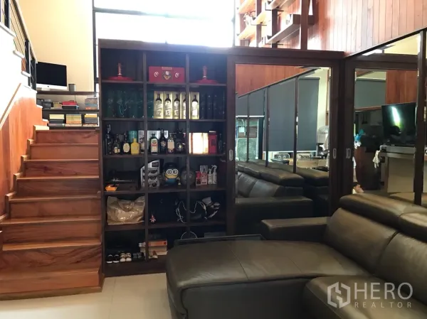 ทาวน์เฮาส์ ขายในSuan Luang, Bangkok - ห้องนั่งเล่นบันไดไม้ ตู้บิวท์อินและตู้กระจก พร้อมโซฟาหนัง