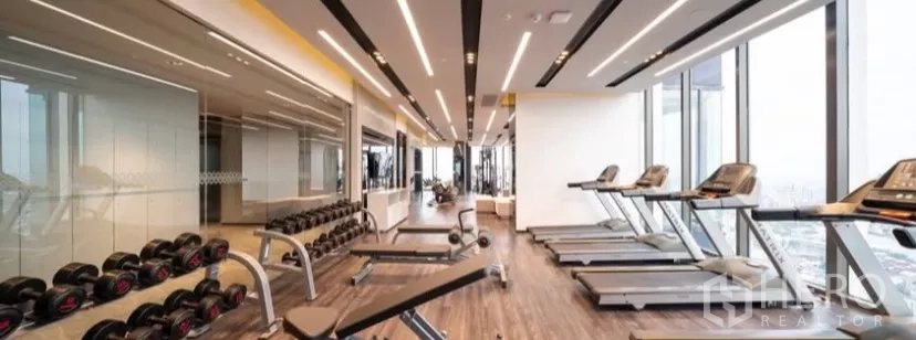 Condominium for rent in Chatuchak, Bangkok - High‑rise fitness gym with treadmills, free weights and panoramic city view.