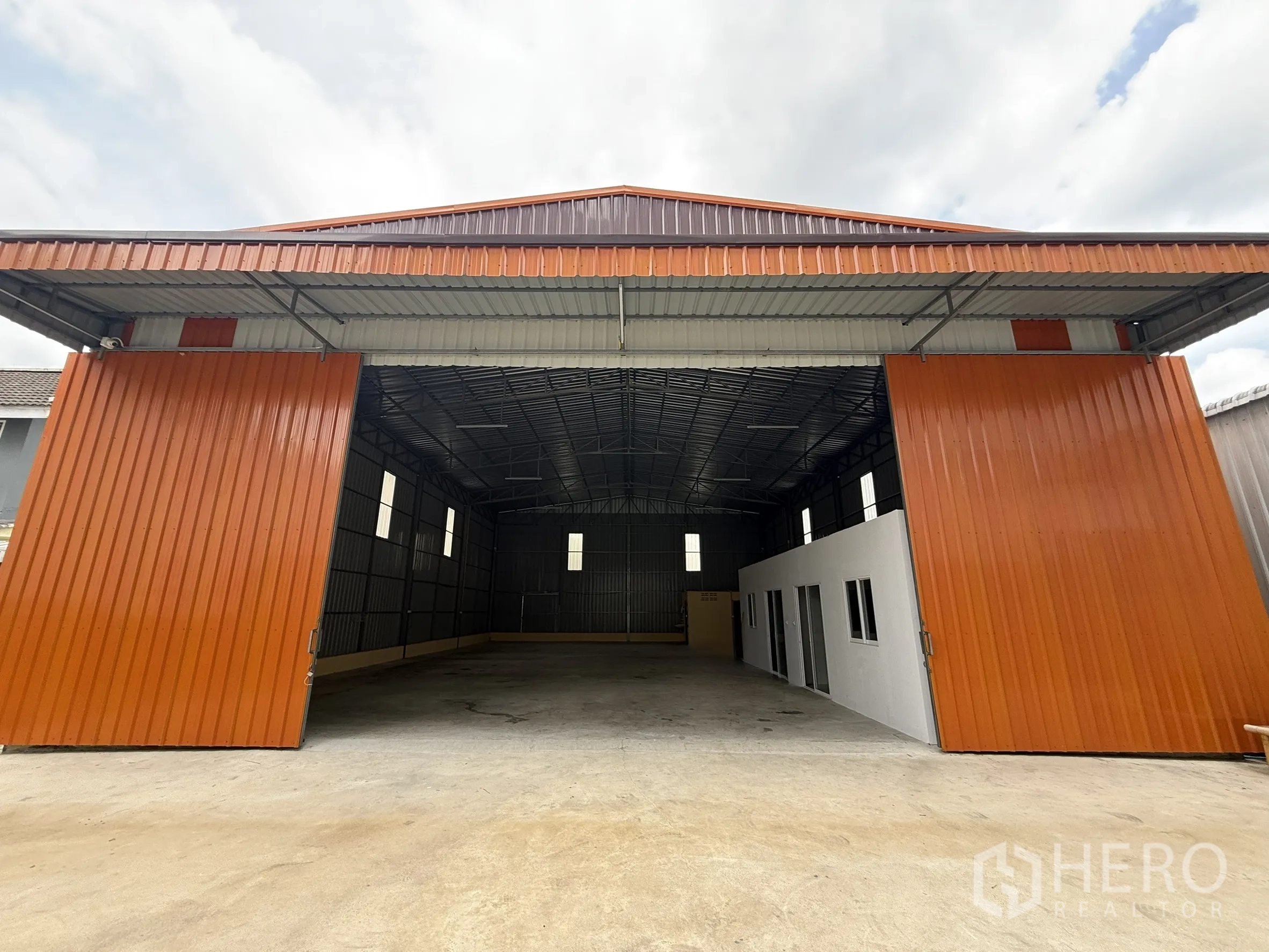 Warehouse for rent in Wang Thonglang, Bangkok - Front view of the warehouse with doors open to the loading area.