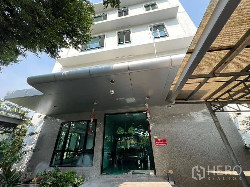 Office Space for sale in Bang Na, Bangkok - Bang Na Bangkok office building facade with granite cladding, canopy and glass entrance.