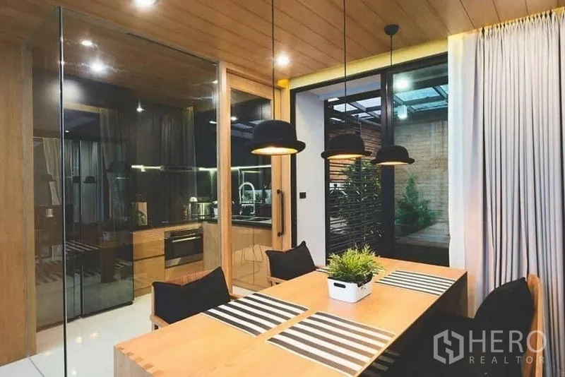 Townhouse for sale in Lak Si, Bangkok - Glass-enclosed home office with multiple desks and ceiling cassette AC.