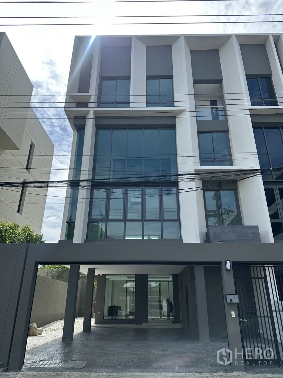 Home Office for rent or sale in Suan Luang, Bangkok - Modern multi-level facade with full-height windows and gated entry.