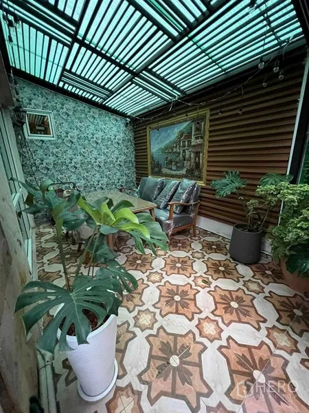 Detached House for sale in Bueng Kum, Bangkok - Covered terrace with patterned tiles, seating area, and decorative wall.