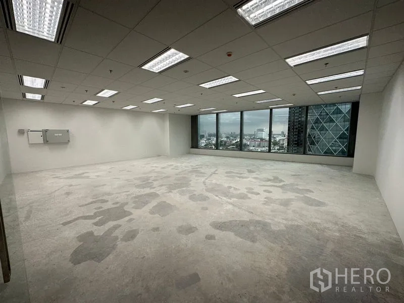 Office Space for rent in Ratchathewi, Bangkok - Spacious office floor with long window wall, city skyline outlook, and adjacent modern glass tower.