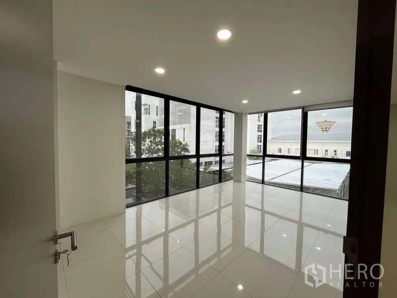 Office Space for rent in Prawet, Bangkok - Corner private office with floor-to-ceiling glass windows and city outlook.