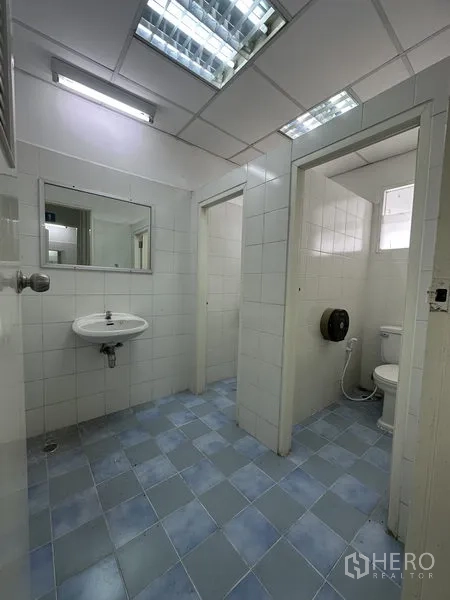 工厂 出租在Nonthaburi - 干净的瓷砖卫生间，带马桶、洗手盆与日光灯