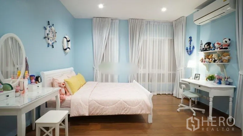 Detached House for rent or sale in Bang Phli, Samut Prakan - Children’s bedroom with pastel blue walls, white furniture and a study desk.