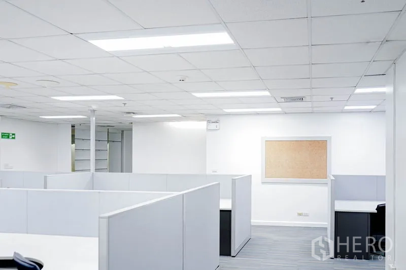 Office Space for rent in Watthana, Bangkok - Corner cubicles with notice board and bright overhead lighting.