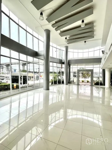 Retail Space for rent in Prawet, Bangkok - Sunlit double-height entrance hall with curtain-wall glazing and modern ceiling baffles.