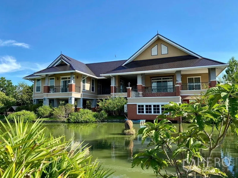 Detached House for sale in Bang Bo, Samut Prakan - Grand detached house with gabled roof beside a private pond and gardens.