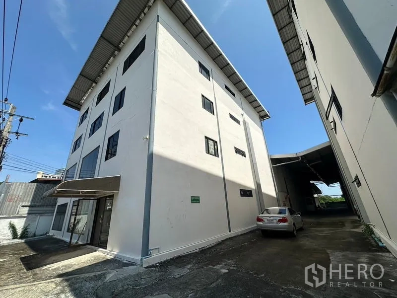 Office Space for rent - Four-storey office building exterior with driveway and on-site parking in Bangkok.