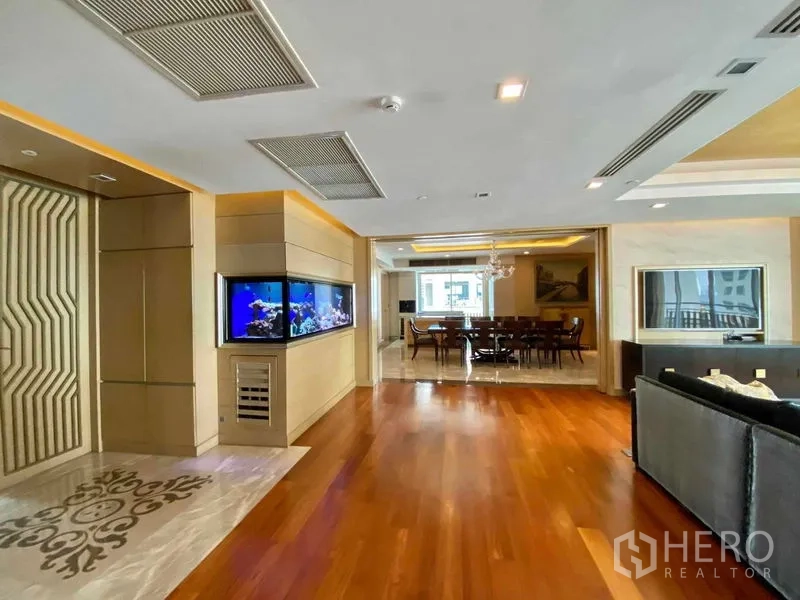 คอนโด ให้เช่าในKhlong Toei, Bangkok - พื้นที่รับแขกและทานอาหารแบบเปิดโล่ง ปูพื้นไม้ พร้อมตู้ปลาบิวท์อินและไฟฝ้า