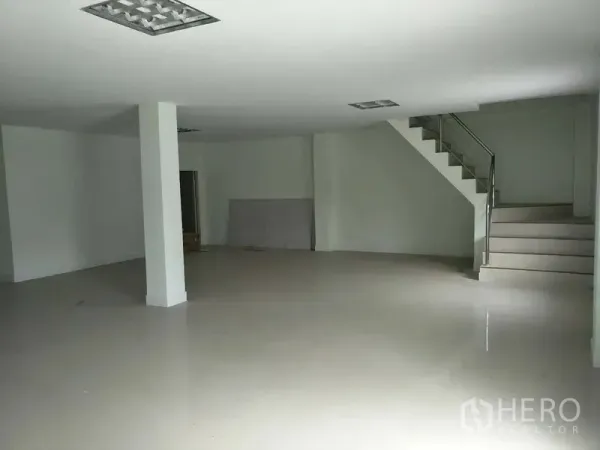 Factory for rent or sale in Bang Phli, Samut Prakan - Clean office area with tiled floor and staircase to a mezzanine level.