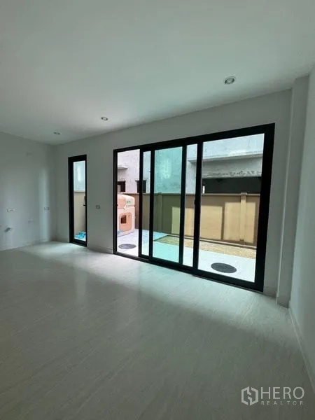 Townhouse for rent - Ground-floor living area opening to a private terrace through sliding doors.