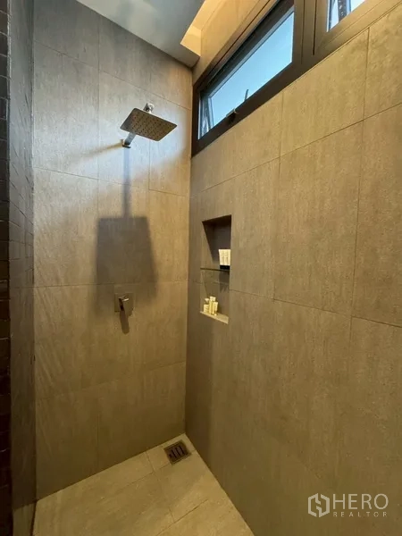 Semi-detached House for rent in Watthana, Bangkok - Bathroom shower area with rainfall head and tiled walls.