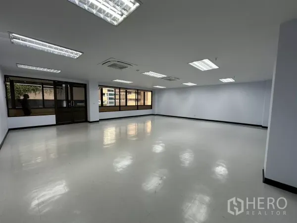 Office Space for rent - Bright open-plan office with large windows, recessed fluorescent lighting and cassette air-conditioning.