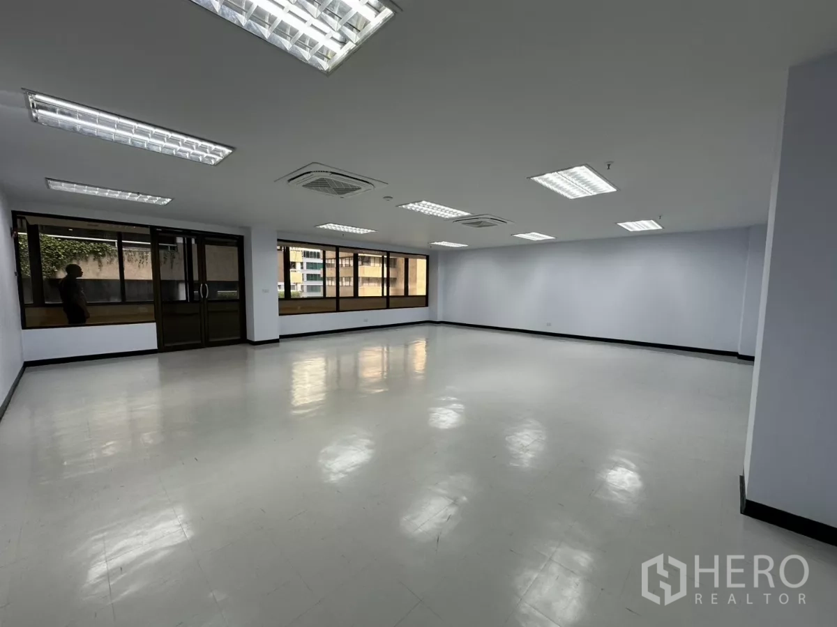 Office Space for rent - Bright open-plan office with large windows, recessed fluorescent lighting and cassette air-conditioning.