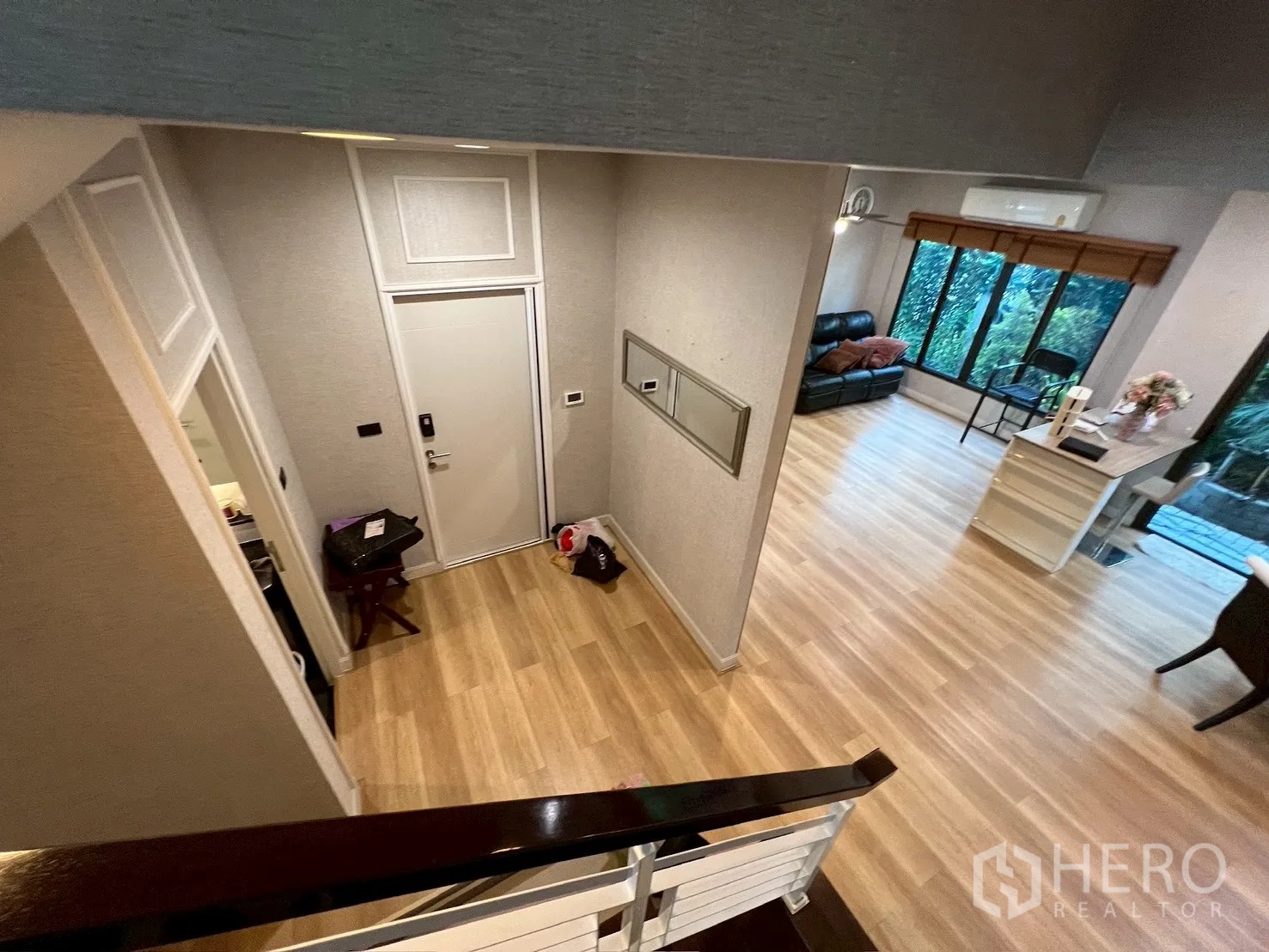 独栋房屋 for rent in Bang Kapi, Bangkok - 从楼梯俯瞰入口大厅与客厅，可见花园景。