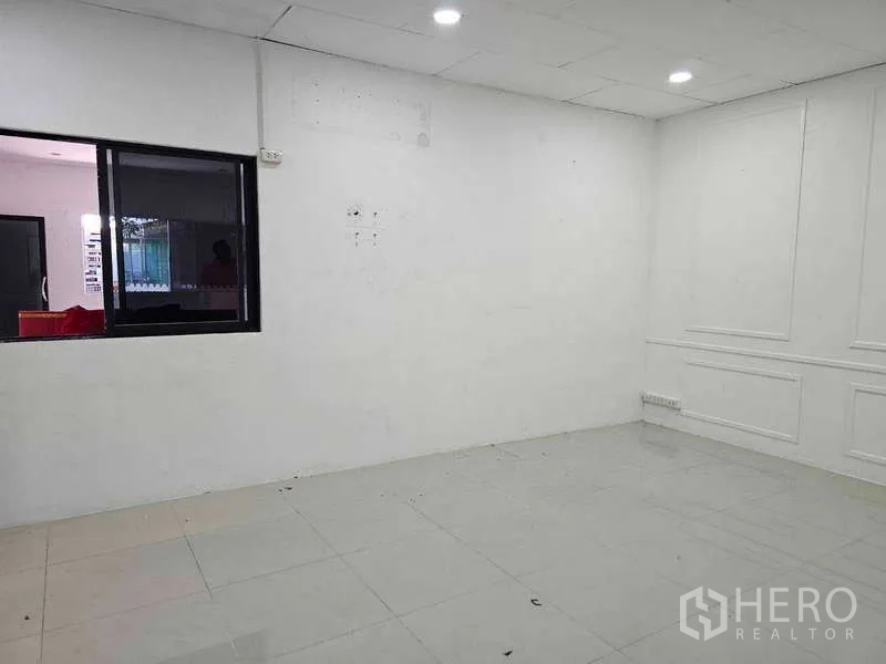 Warehouse for rent or sale in Khlong Toei, Bangkok - Clean white office room with recessed lighting and tiled flooring within the facility.