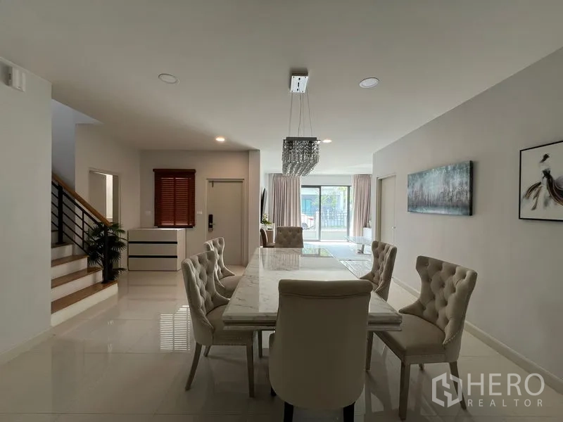 Detached House for rent in Bang Phli, Samut Prakan - Dining zone with crystal light, staircase and sliding doors to terrace.