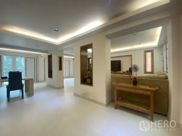 Detached House for sale in Khlong Toei, Bangkok - Open-plan lounge and dining area with recessed ceilings and large windows.