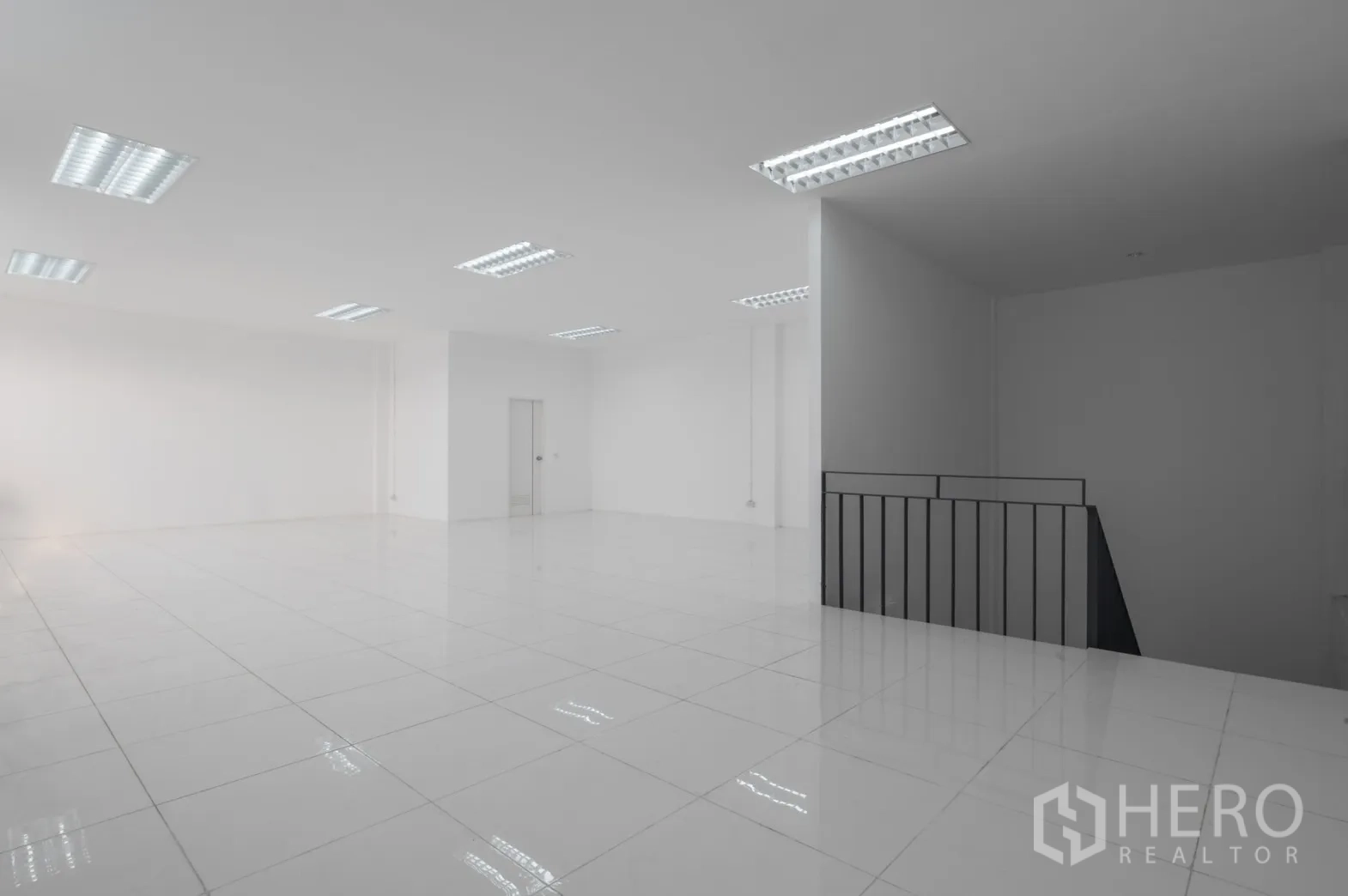 Factory for rent in Pathum Thani - Second-floor office with railing and polished tile floors.