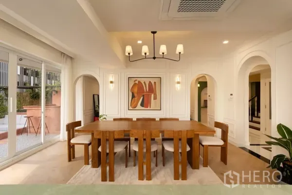 Condominium for sale in Watthana, Bangkok - Spacious dining room in Phrom Phong condominium with wooden table for eight and terrace access.