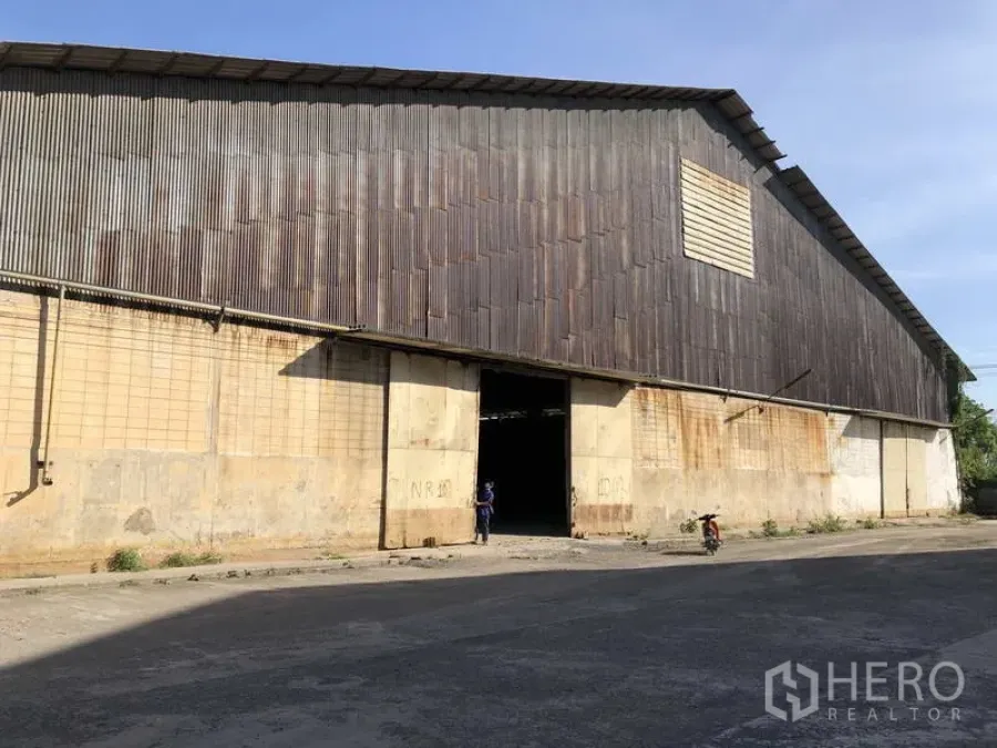 Warehouse for rent in Phra Nakhon Si Ayutthaya - Front facade of large warehouse with sliding entrance door and loading access.
