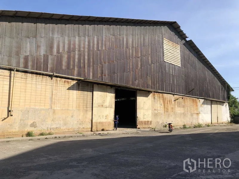 Warehouse for rent in Phra Nakhon Si Ayutthaya - Front facade of large warehouse with sliding entrance door and loading access.