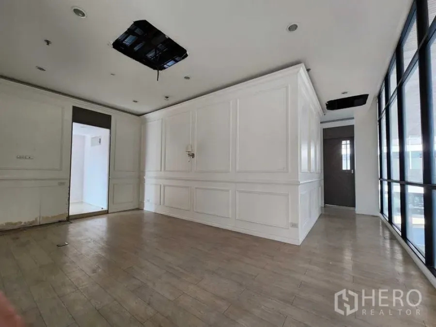 Office Space for rent in Yan Nawa, Bangkok - Main workspace with white wainscoting and wall-to-wall glazing.