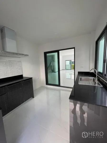 Detached House for rent - Kitchen view with sink, sliding glass door and side window.