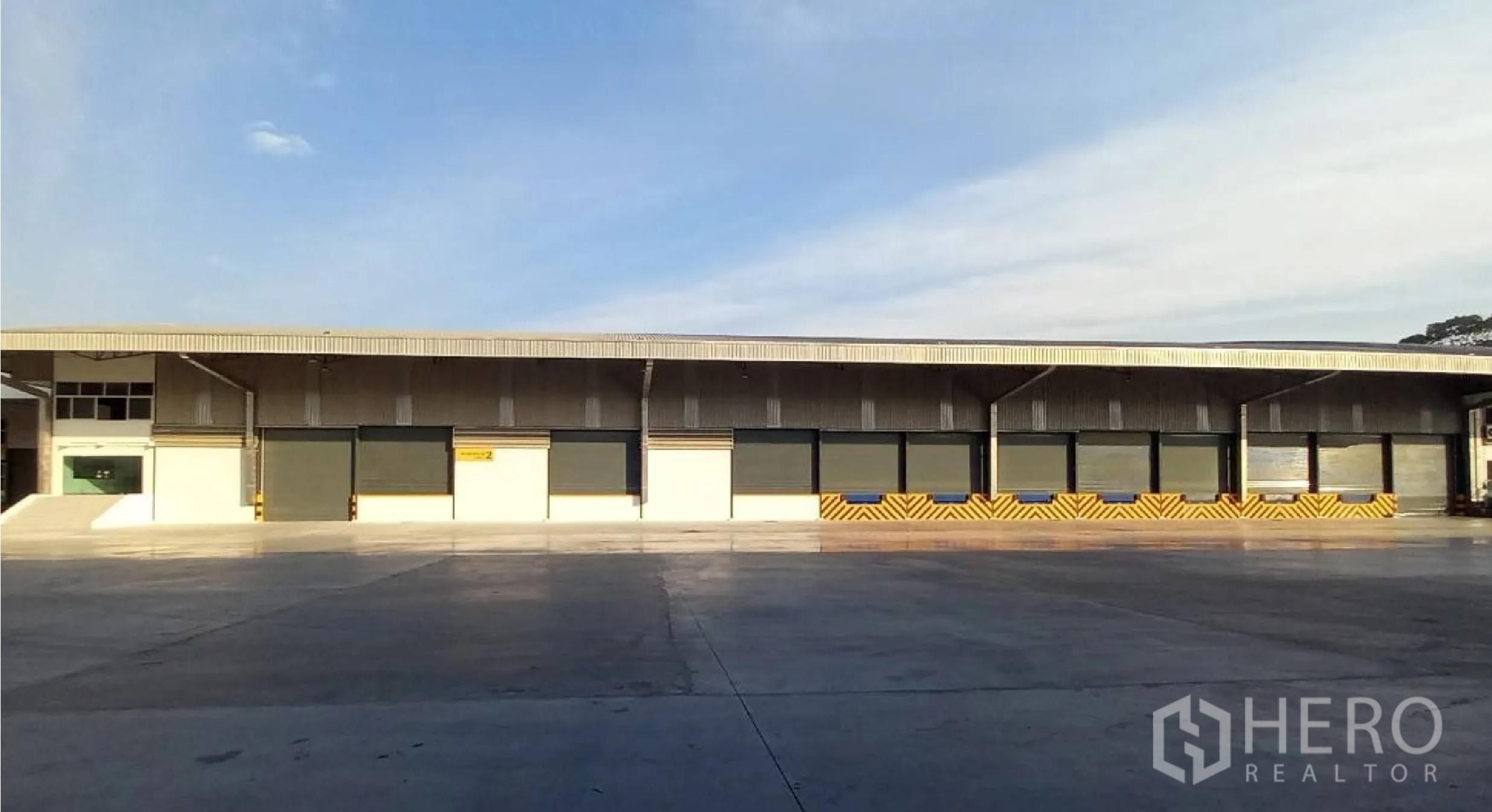 Factory for rent in Si Racha, Chon Buri - Factory exterior showing multiple dock-high loading bays with levelers and shutters.