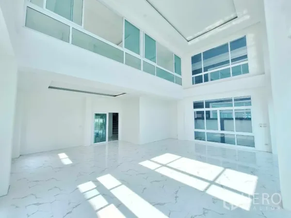 Office Space for sale in Bueng Kum, Bangkok - Spacious showroom-style hall with mezzanine glazing and white interiors.