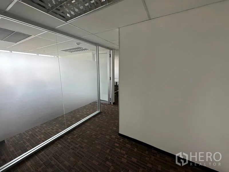 Office Space for rent in Watthana, Bangkok - Glass-partitioned corridor with suspended ceiling and recessed lights.