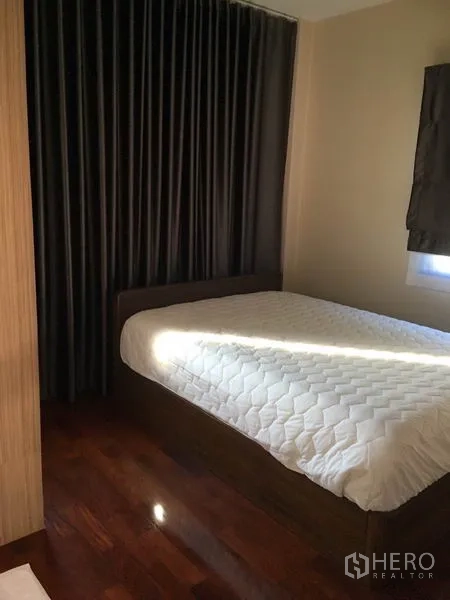 独立式住宅 出售在Khlong Toei, Bangkok - 卧室采光良好，床铺、深色窗帘与木地板。