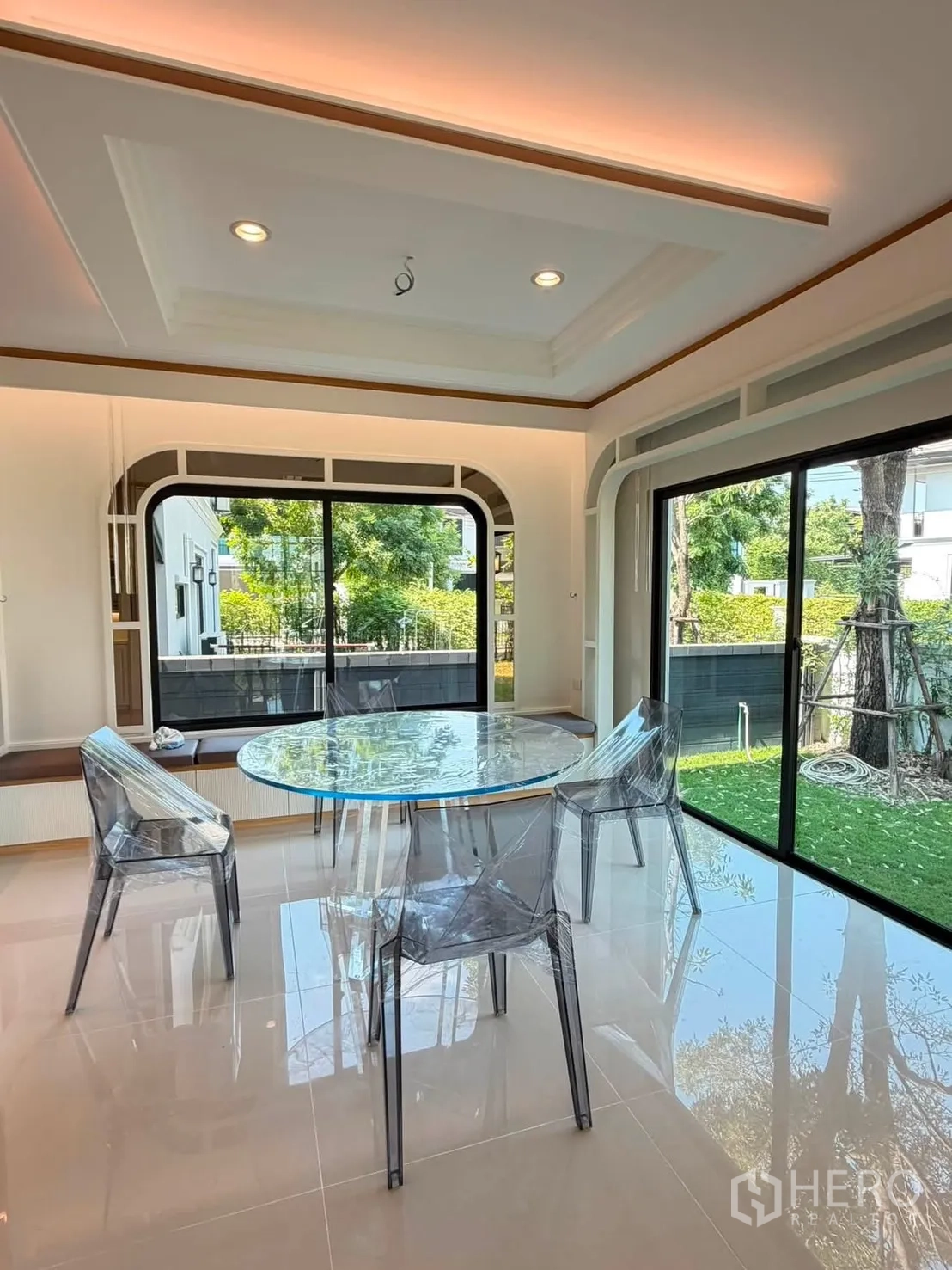 Detached House for rent or sale in Prawet, Bangkok - Bright dining area with round table and sliding glass doors to garden.