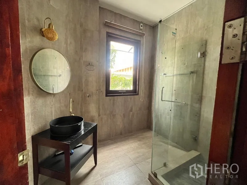 Detached House for sale in Prawet, Bangkok - Bathroom with glass shower enclosure, black vessel sink, and window.