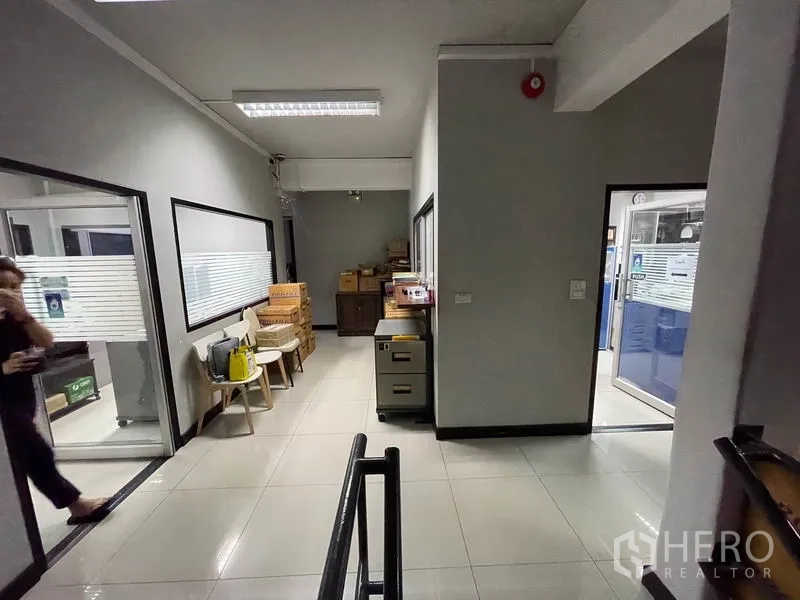Office Space for rent in Khlong Toei, Bangkok - Hallway by the staircase leading to office rooms with bright lighting.