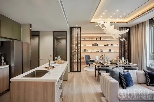 Condominium for sale in Bang Kho Laem, Bangkok - Open-plan kitchen, dining and living area with island counter, backlit shelves and statement chandelier.