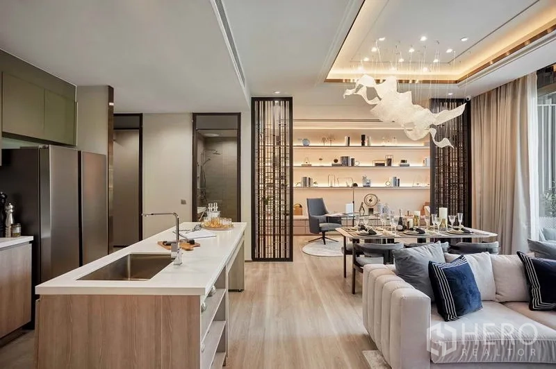 Condominium for sale in Bang Kho Laem, Bangkok - Open-plan kitchen, dining and living area with island counter, backlit shelves and statement chandelier.