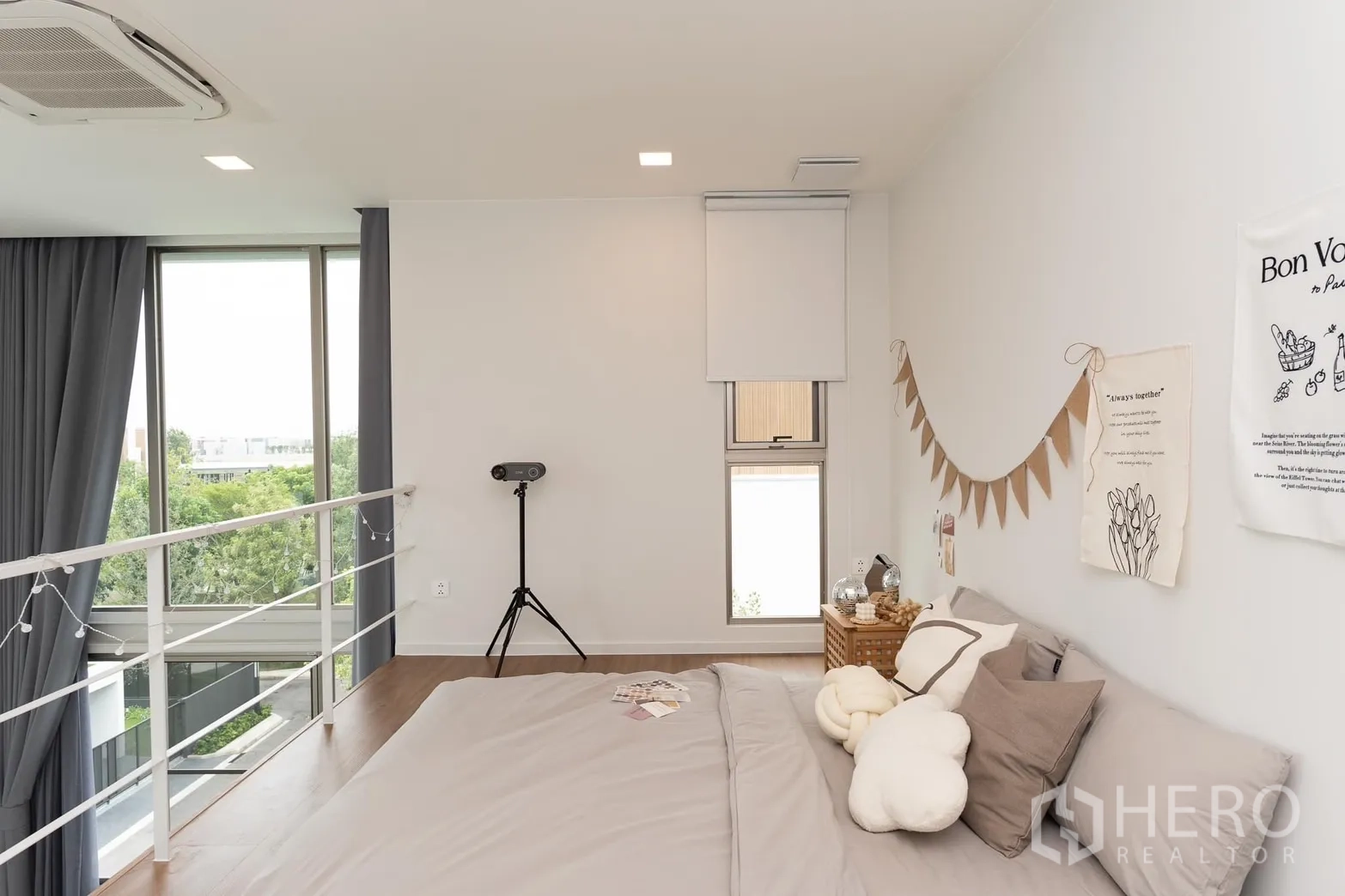Detached House for rent in Saphan Sung, Bangkok - Mezzanine bedroom with large windows, railing and neighborhood green views